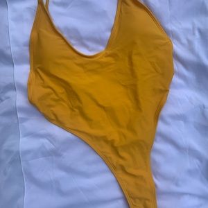 Never worn one piece thong bathing suit!